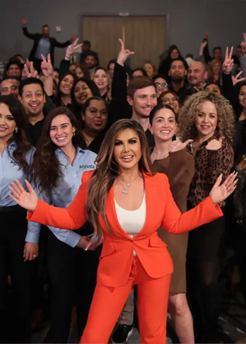 Adriana Gallardo, in an orange suit, with her team