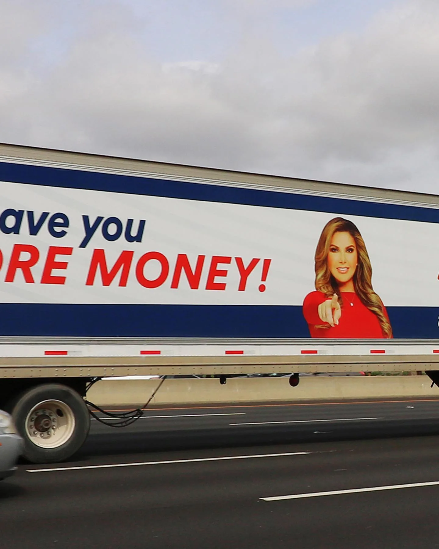 An Adriana's Insurance truck ad on the highway: "I'll save you more money!"