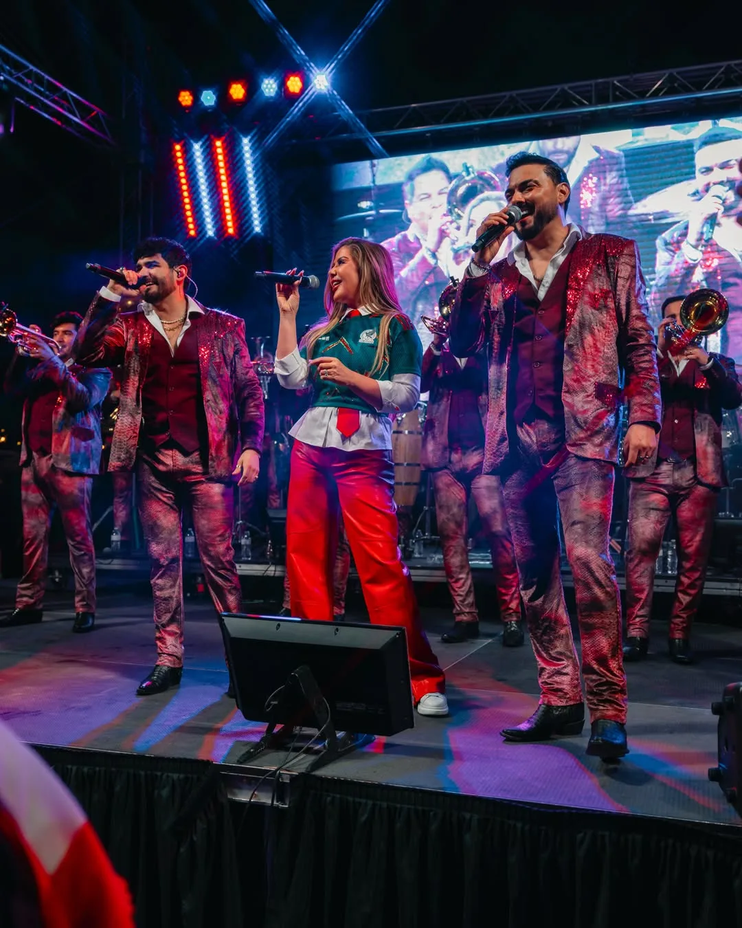 Adriana Gallardo on stage with a band at a concert
