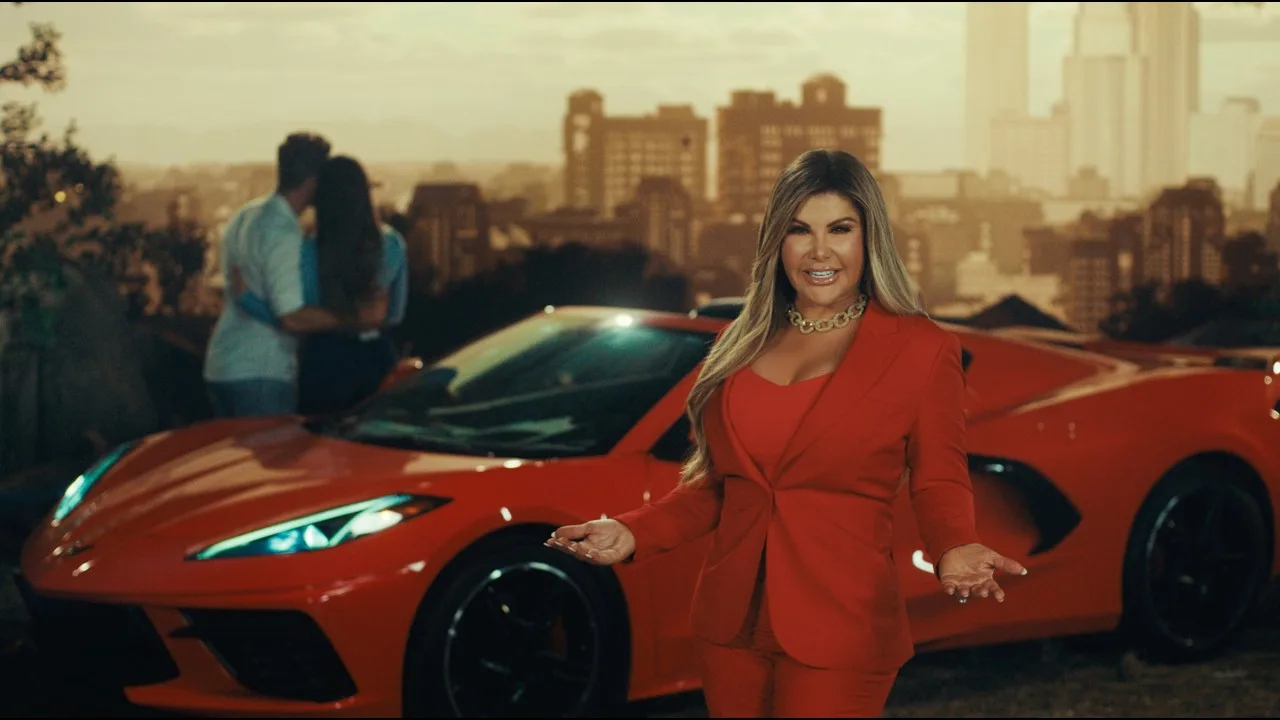 Adriana Gallardo beside a red sports car in an Adriana's Insurance TV commercial